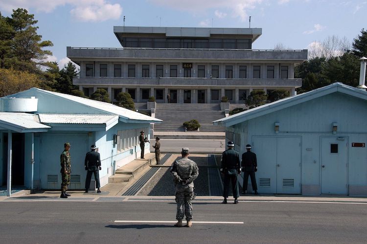 Photo: A view in May 2007 from South Korea towards North Korea in the Joint Security Area at Panmunjom. North and South Korean military personnel, as well as a single US soldier, are to be seen. Credit: Wikimedia Commons.