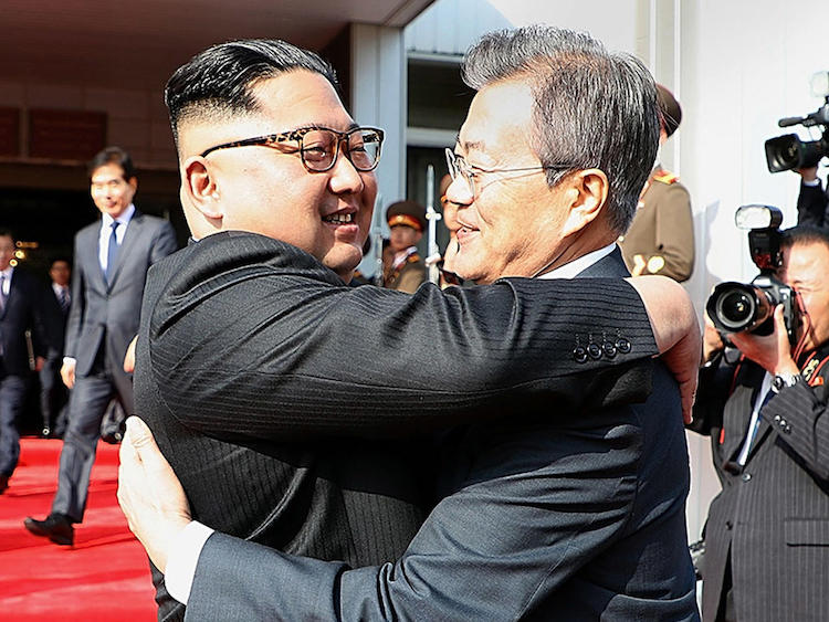 Photo: North Korean leader Kim Jong Un (left) and South Korean President Moon Jae-in embrace Saturday (May 26, 2018) on the North Korean side of the shared inter-Korean area of Panmunjom. Credit: South Korean Presidential Blue House / Getty Images