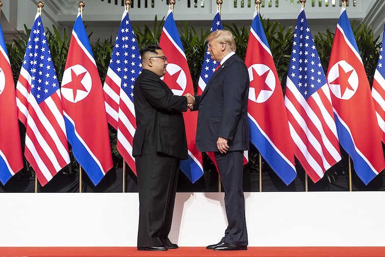 Photo: Kim and Trump shaking hands at the red carpet during the DPRK-USA Singapore Summit on June 12, 2018. Credit: Wikimedia Commons.