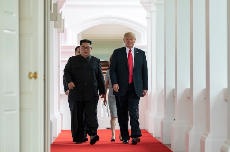 Photo: Kim and Trump walking to the summit room during the DPRK–USA Singapore Summit on June 12, 2018. Credit: Wikimedia Commons.