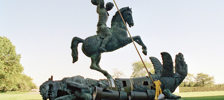 Photo: Sculpture depicting St. George slaying the dragon. The dragon is created from fragments of Soviet SS-20 and United States Pershing nuclear missiles. UN Photo/Milton Grant.